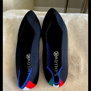 Never used, black Rothy slides.